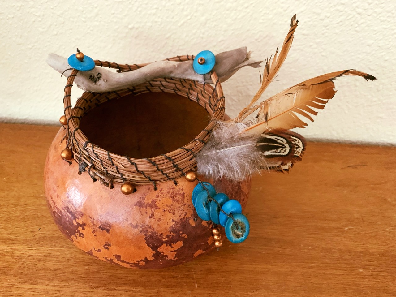 Brown gourd with turquois beads